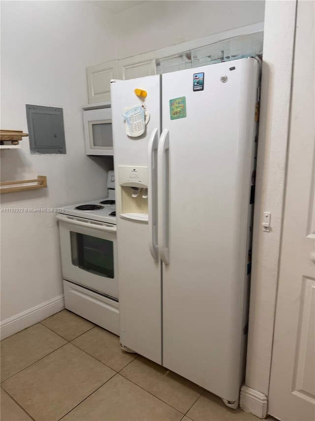 kitchen with white appliances, white cabinetry, light tile patterned floors, and electric panel