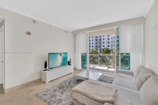 living area with visible vents, crown molding, baseboards, and carpet floors