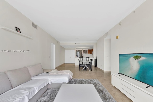 living area with visible vents and finished concrete floors