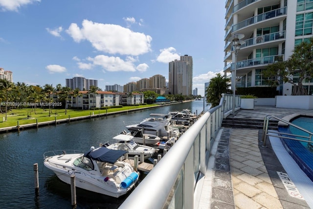 balcony featuring a city view and a water view
