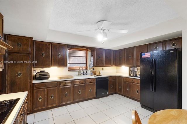 kitchen featuring a ceiling fan, light countertops, a textured ceiling, a sink, and black appliances