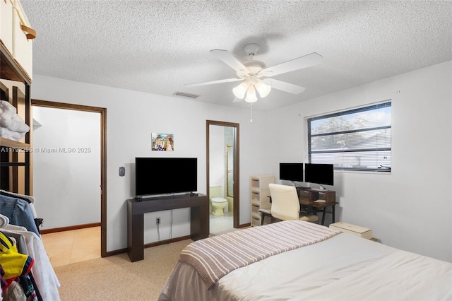 bedroom featuring ceiling fan, a textured ceiling, and visible vents