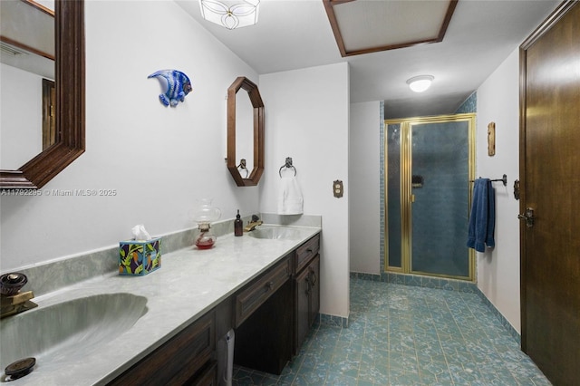 full bath with double vanity, a sink, and a stall shower