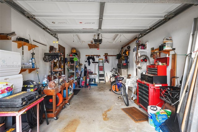 garage with a workshop area and a garage door opener