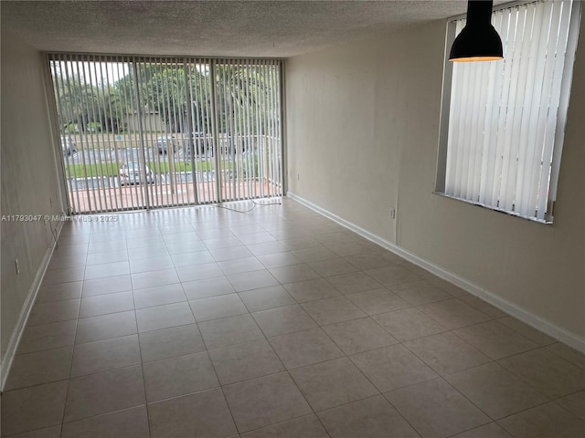 13120 SW 92nd Ave Unit B-222, Miami, FL 33176 - empty room with tile patterned floors, baseboards, and a textured ceiling