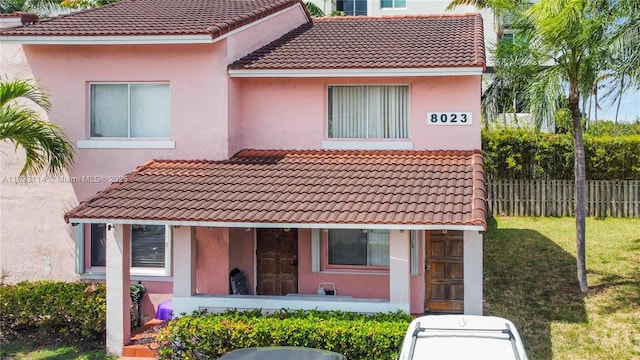 8023 Lake Dr Unit 201, Doral, FL 33166 - mediterranean / spanish home with stucco siding, a front lawn, fence, and a tile roof