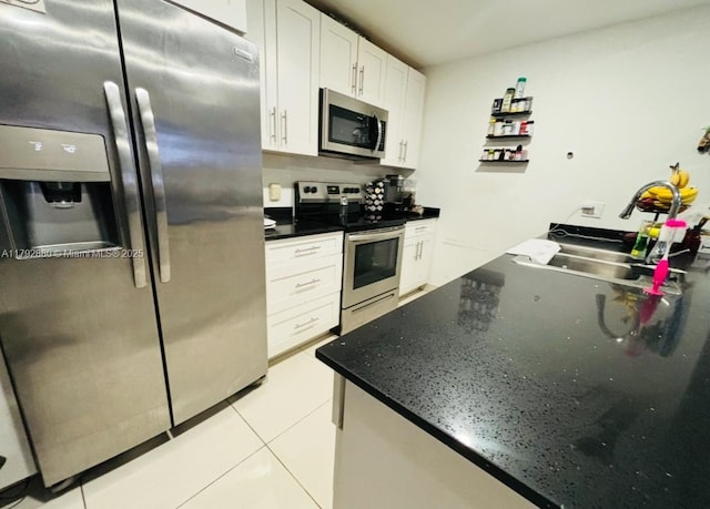 25836 SW 139th Path, Homestead, FL 33032 - kitchen featuring stainless steel appliances, a sink, white cabinetry, light tile patterned flooring, and dark stone countertops