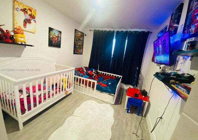 25836 SW 139th Path, Homestead, FL 33032 - bedroom with wood finished floors and a nursery area