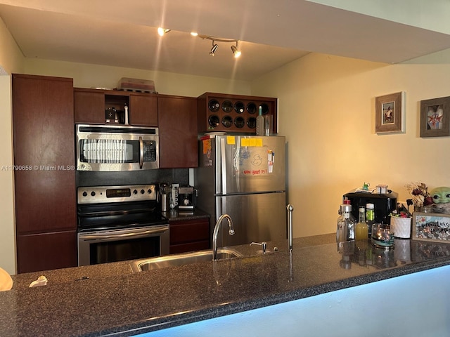 8120 Geneva Ct Unit 551, Doral, FL 33166 - kitchen with track lighting, a sink, dark stone countertops, and stainless steel appliances