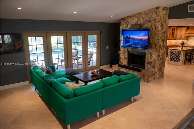 living area featuring a fireplace, french doors, recessed lighting, and visible vents