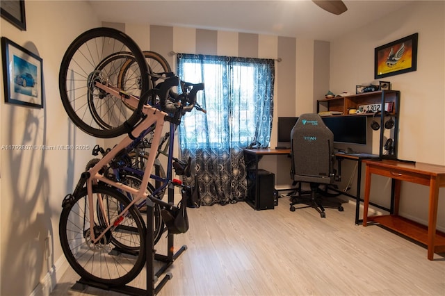home office featuring baseboards and wood finished floors