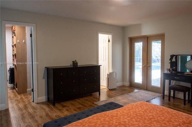 bedroom with french doors, baseboards, wood finished floors, and access to exterior