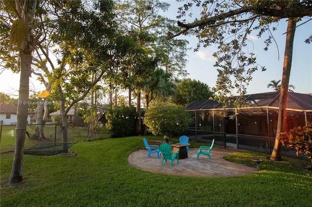 view of yard with a lanai, a patio area, and fence