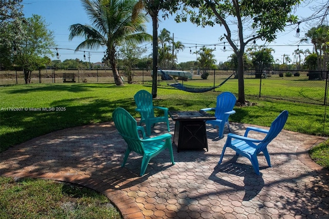 view of patio / terrace featuring a fire pit and fence