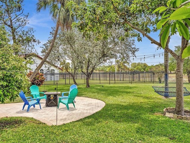 view of yard featuring an outdoor fire pit and a patio area