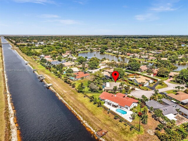 aerial view of residential area featuring a large body of water