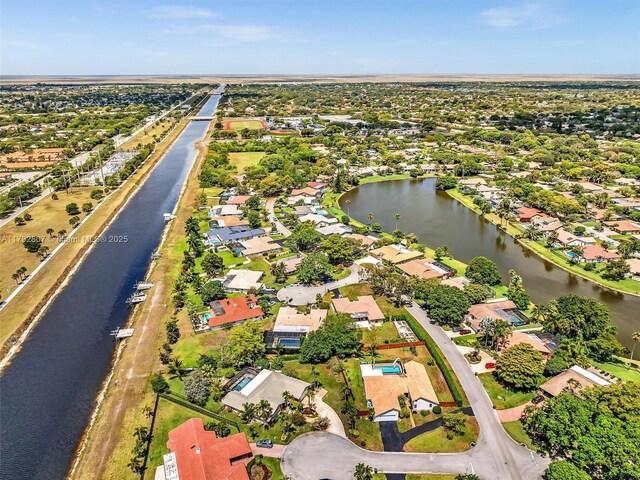 aerial perspective of suburban area featuring a nearby body of water