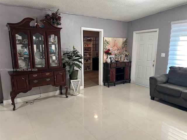 living room with tile patterned flooring and a textured ceiling