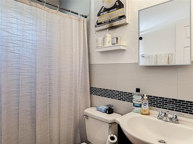 14320 NE 18th Ave, Miami, FL 33181 - bathroom with toilet, tile walls, a sink, and tasteful backsplash