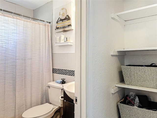 14320 NE 18th Ave, Miami, FL 33181 - bathroom with vanity, a textured wall, toilet, and tile walls