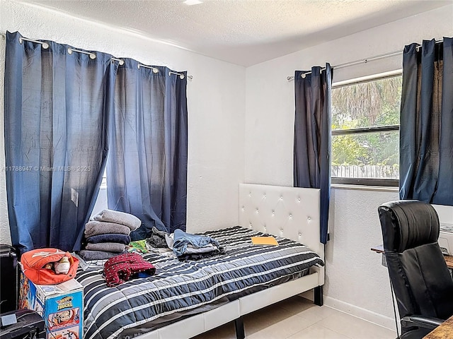 14320 NE 18th Ave, Miami, FL 33181 - tiled bedroom featuring baseboards, a textured ceiling, and a textured wall
