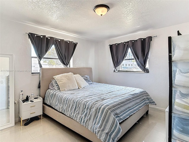 14320 NE 18th Ave, Miami, FL 33181 - bedroom with tile patterned floors, baseboards, a textured wall, and a textured ceiling