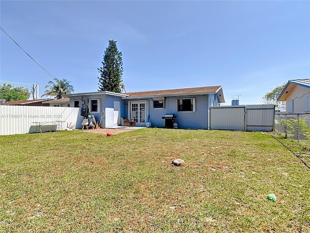 14320 NE 18th Ave, Miami, FL 33181 - rear view of property featuring a lawn, a fenced backyard, and french doors