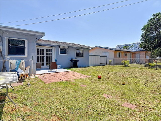 14320 NE 18th Ave, Miami, FL 33181 - back of house featuring french doors, a patio area, fence, a yard, and stucco siding