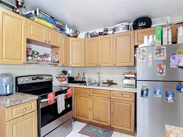 14320 NE 18th Ave, Miami, FL 33181 - kitchen featuring light countertops, light tile patterned floors, light brown cabinets, and stainless steel appliances