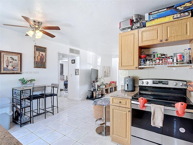 14320 NE 18th Ave, Miami, FL 33181 - kitchen with stainless steel electric range, ceiling fan, light brown cabinets, light countertops, and visible vents