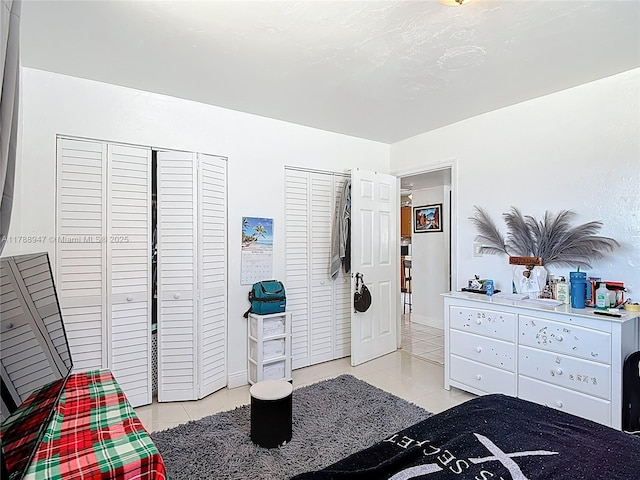 14320 NE 18th Ave, Miami, FL 33181 - bedroom with light tile patterned flooring, baseboards, and multiple closets