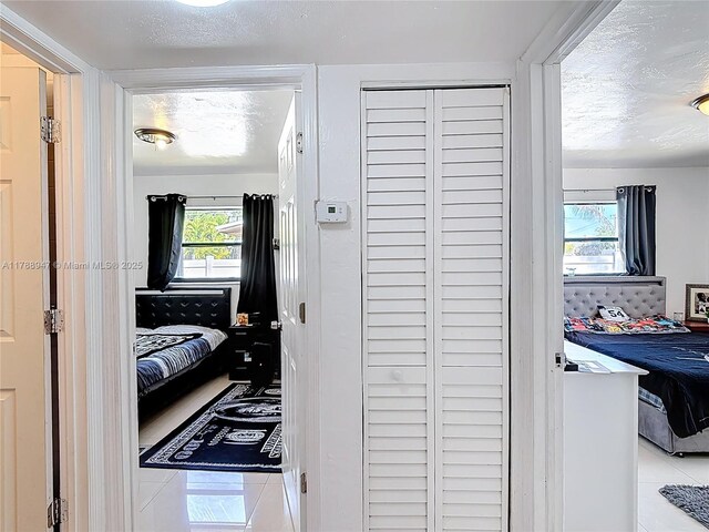 14320 NE 18th Ave, Miami, FL 33181 - hall featuring tile patterned flooring and a textured ceiling