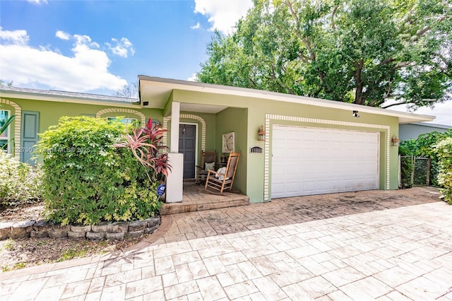 11560 NW 26th St, Plantation, FL 33323 - view of front of house featuring decorative driveway, a garage, and stucco siding