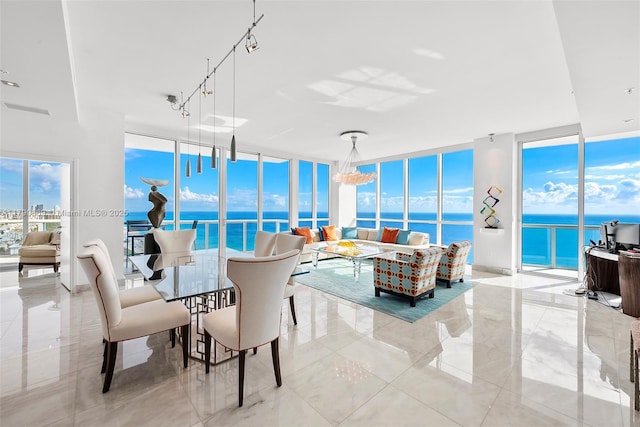 living area with a water view and floor to ceiling windows