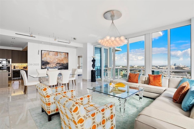 living room featuring a wall of windows, marble finish floor, beverage cooler, and a notable chandelier