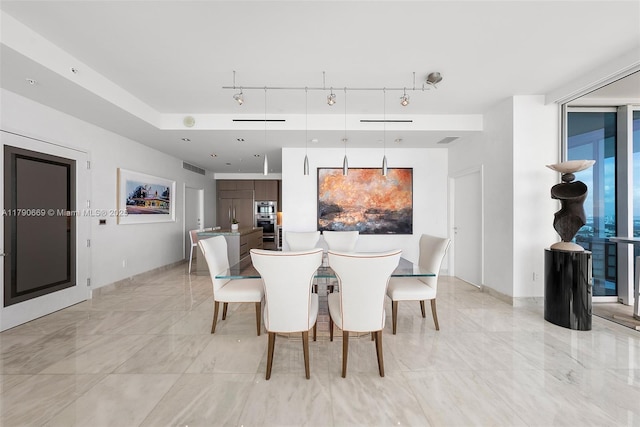 dining area featuring visible vents, rail lighting, marble finish floor, and baseboards