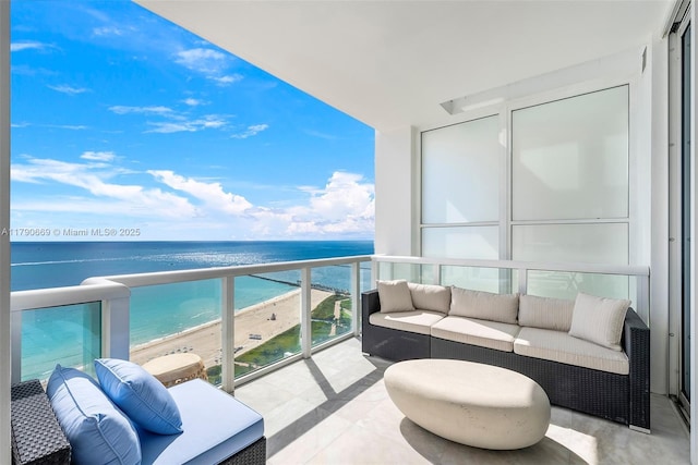 balcony featuring a water view and a view of the beach