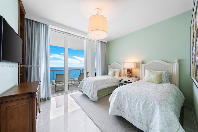 bedroom featuring a water view and access to exterior