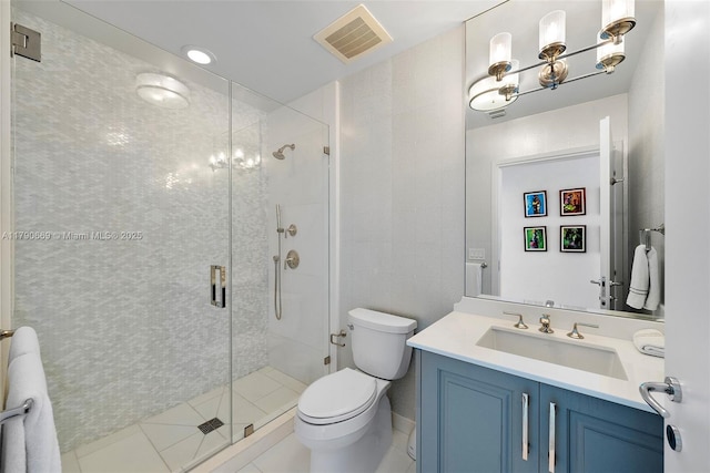 bathroom featuring visible vents, a shower stall, toilet, and vanity
