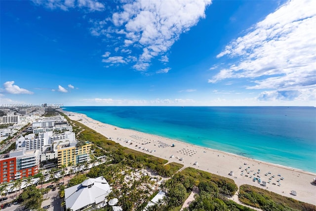 birds eye view of property with a water view and a view of the beach