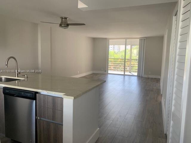 kitchen featuring stainless steel dishwasher, open floor plan, modern cabinets, a sink, and dark wood finished floors