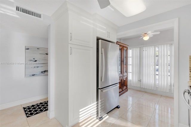 kitchen featuring visible vents, freestanding refrigerator, ceiling fan, and light tile patterned floors