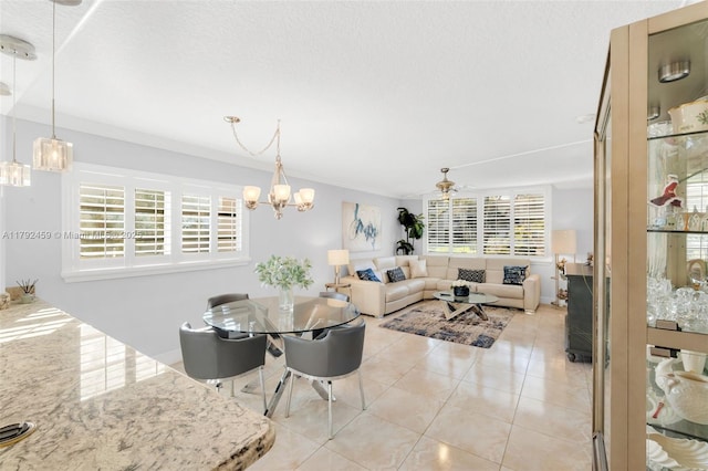 dining space featuring crown molding, a textured ceiling, light tile patterned floors, and an inviting chandelier