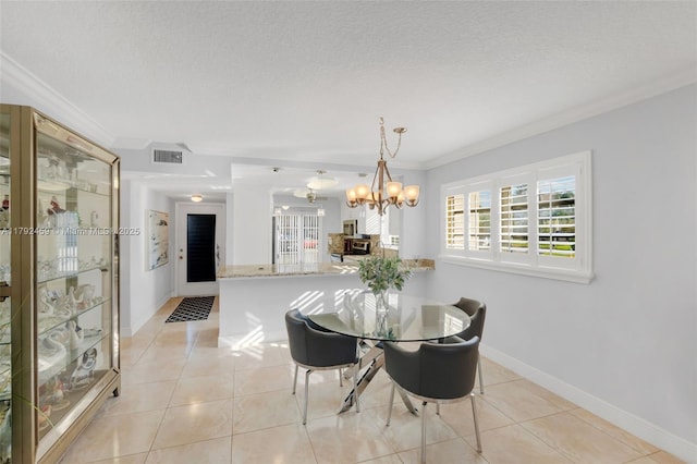 dining area featuring visible vents, ornamental molding, a textured ceiling, light tile patterned floors, and a notable chandelier