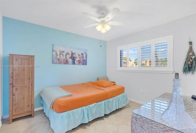 bedroom with baseboards, ceiling fan, and light tile patterned flooring