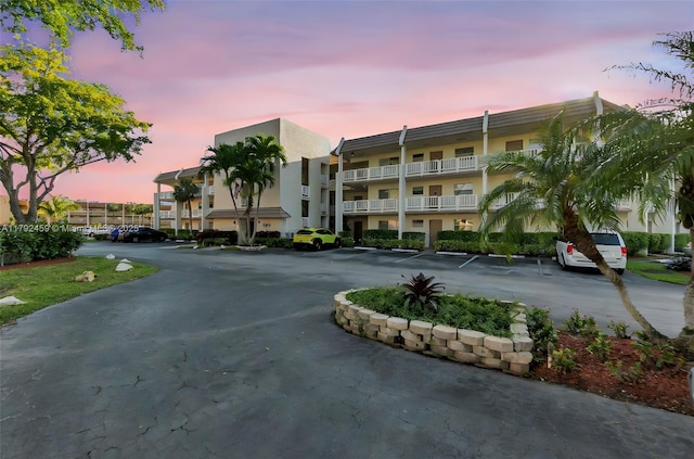 view of building exterior featuring uncovered parking