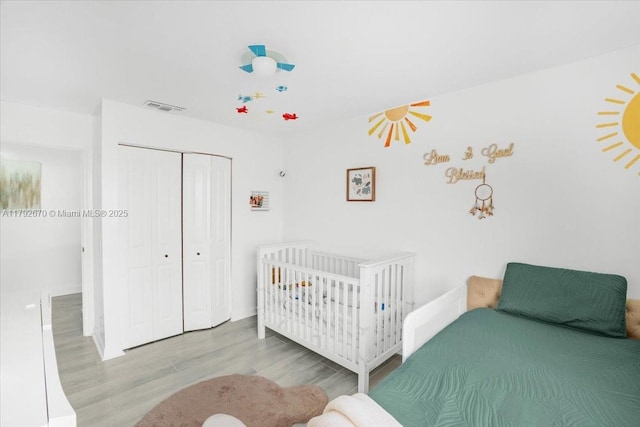 1820 Vista Way, Margate, FL 33063 - bedroom with visible vents, wood finished floors, baseboards, a crib, and a closet
