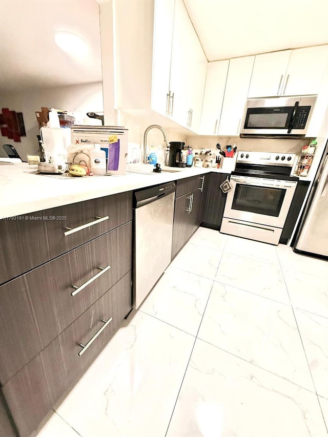 1401 NE 191st St Unit D201, Miami, FL 33179 - kitchen with a sink, light countertops, marble finish floor, and appliances with stainless steel finishes