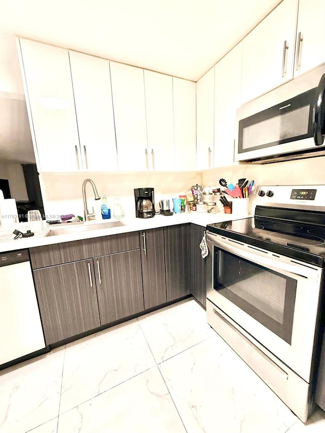 1401 NE 191st St Unit D201, Miami, FL 33179 - kitchen featuring marble finish floor, stainless steel microwave, a sink, dishwasher, and range with electric cooktop