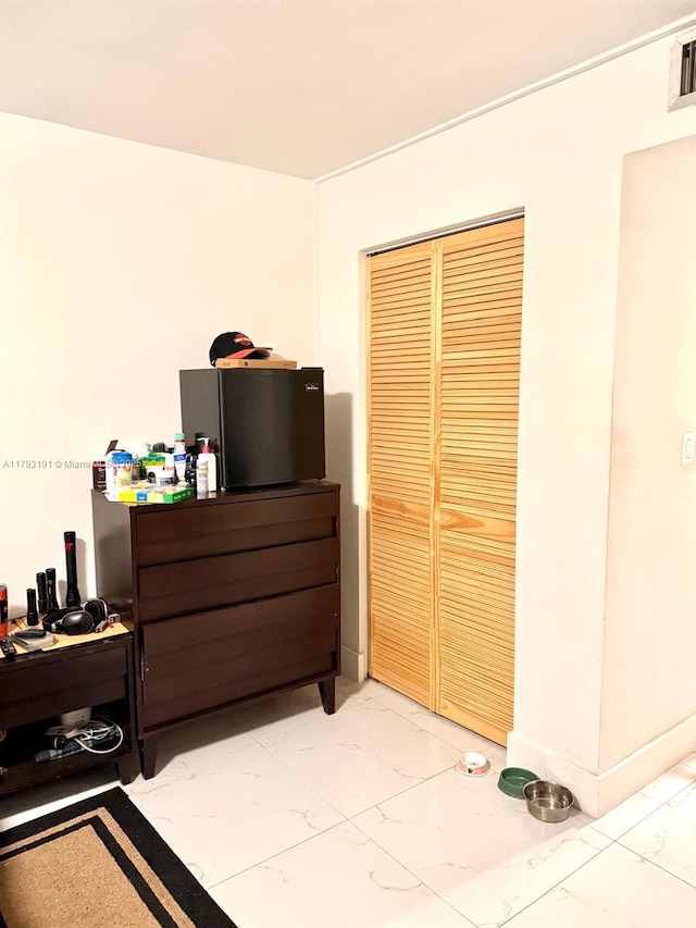 1401 NE 191st St Unit D201, Miami, FL 33179 - bedroom featuring marble finish floor and a closet